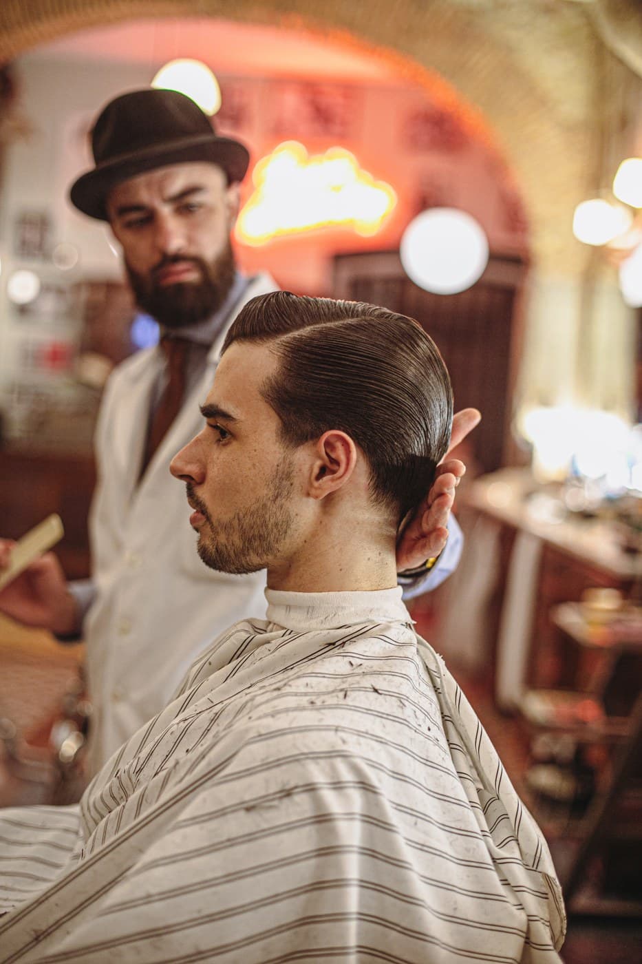 Barbershop editorial portrait with warm neon tones