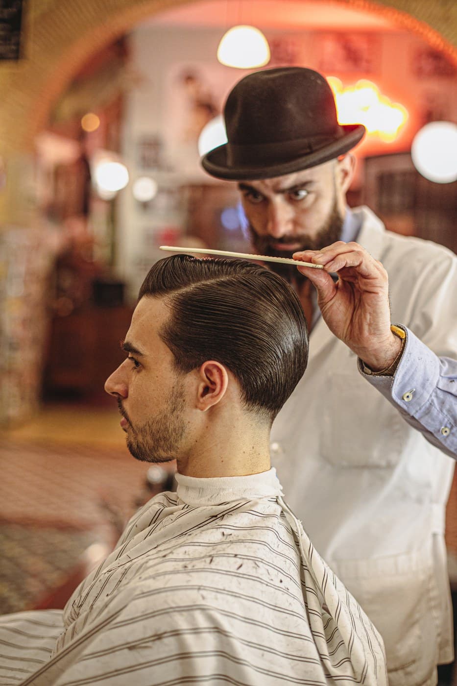 Barbershop portrait — barber with comb, editorial