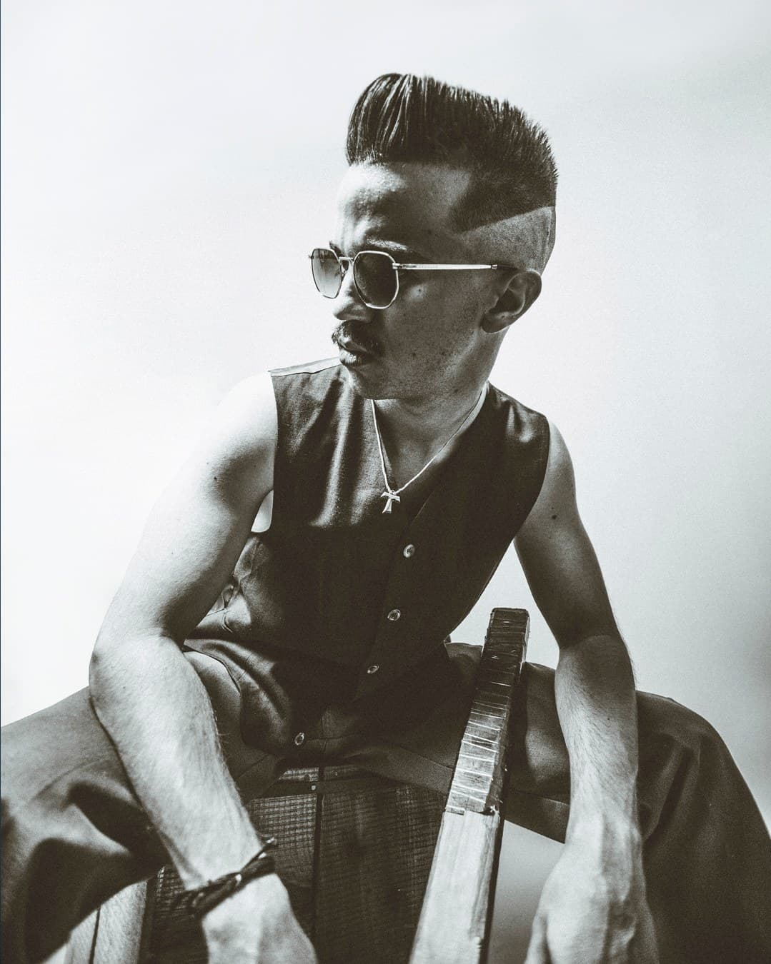 Black and white fashion editorial — high pompadour with sunglasses and plank