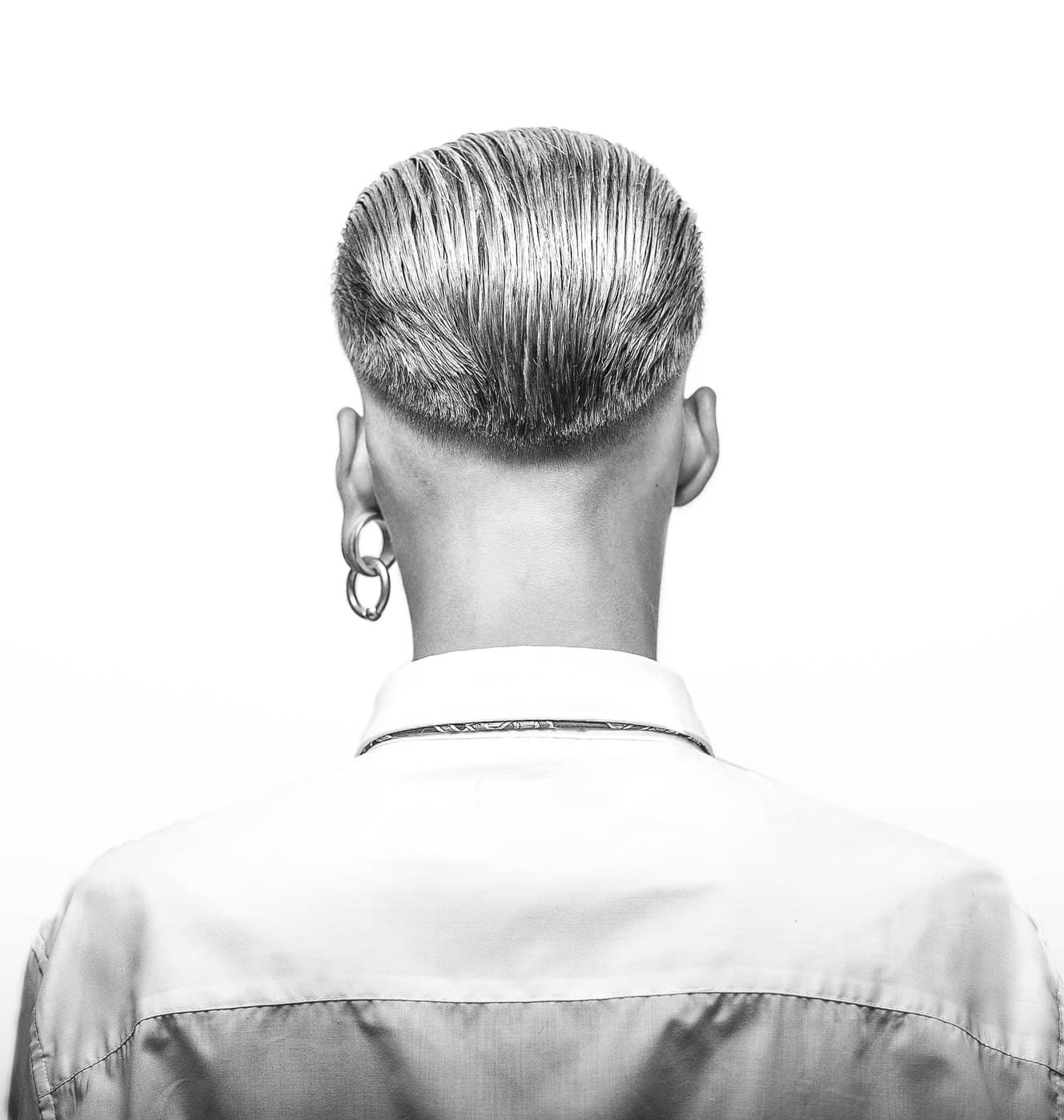Black and white — back of head, elegant slicked pompadour and fade on white