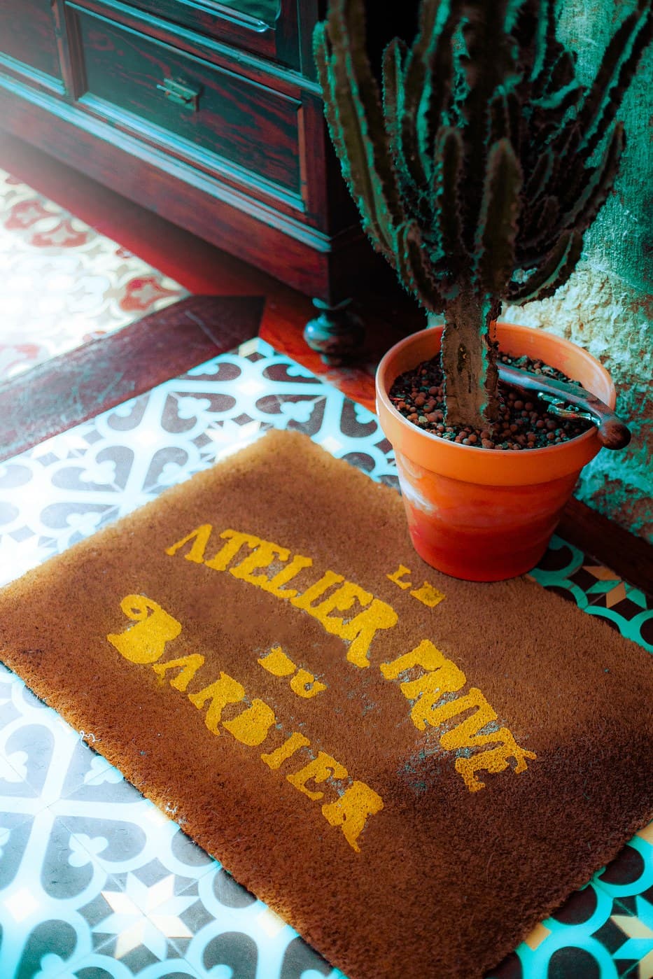 Le Atelier Privé du Barbier branded doormat detail with cactus and mosaic tiles